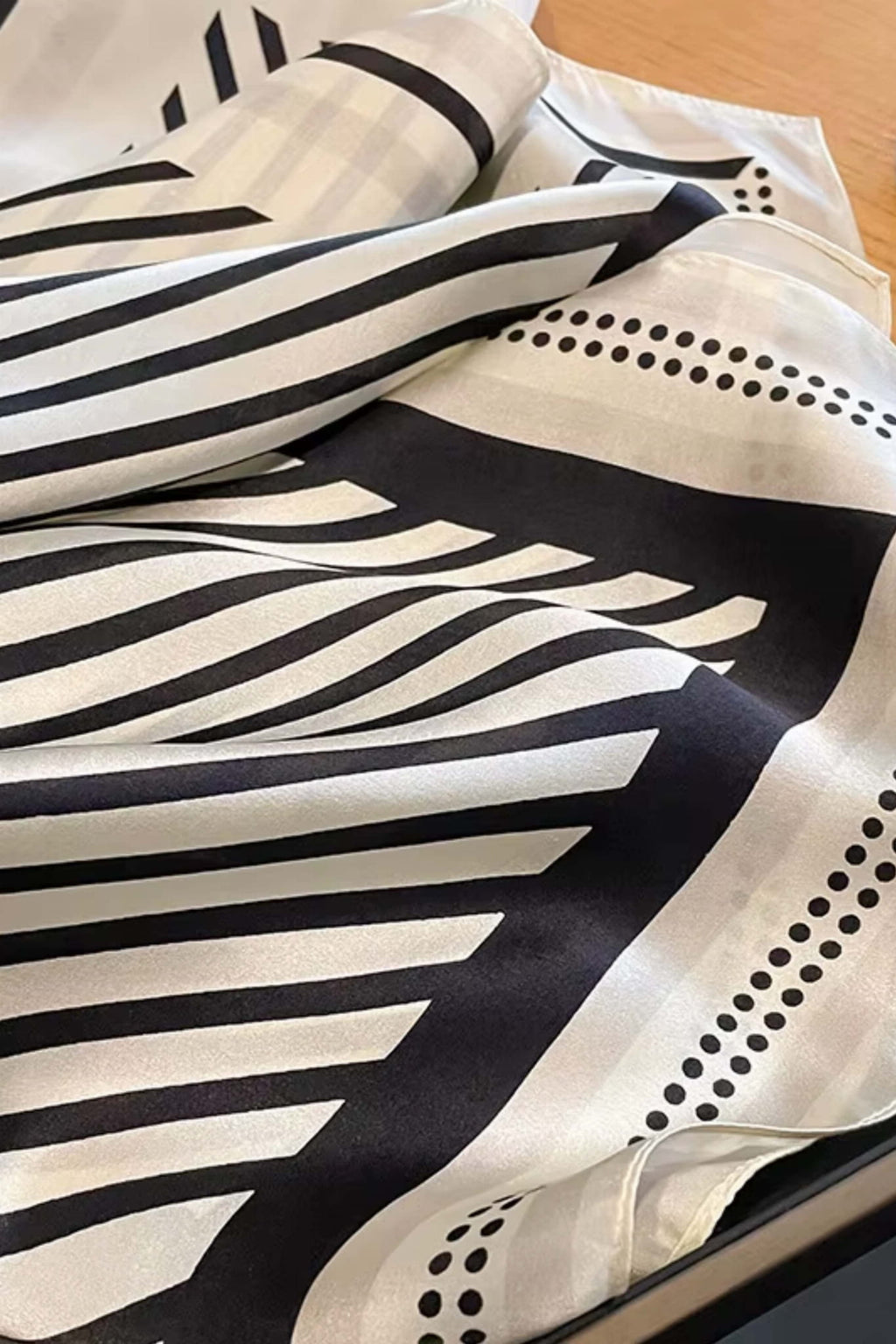 Černo-bežový šátek zblízka, ukazující jemnou strukturu přírodního hedvábí | KAMEA | Spironik.pl