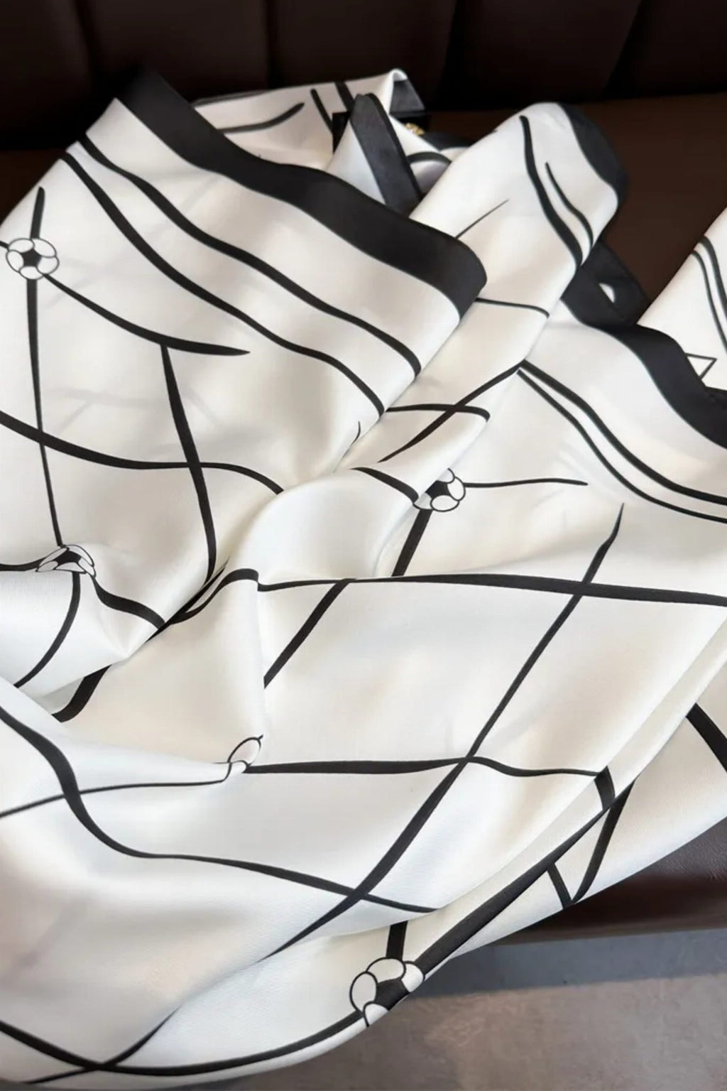 Widok boku apaszki „Czarno-Biała Elegancja” ukazujący jej miękką fakturę i elegancki design | KAMEA | Spironik.pl