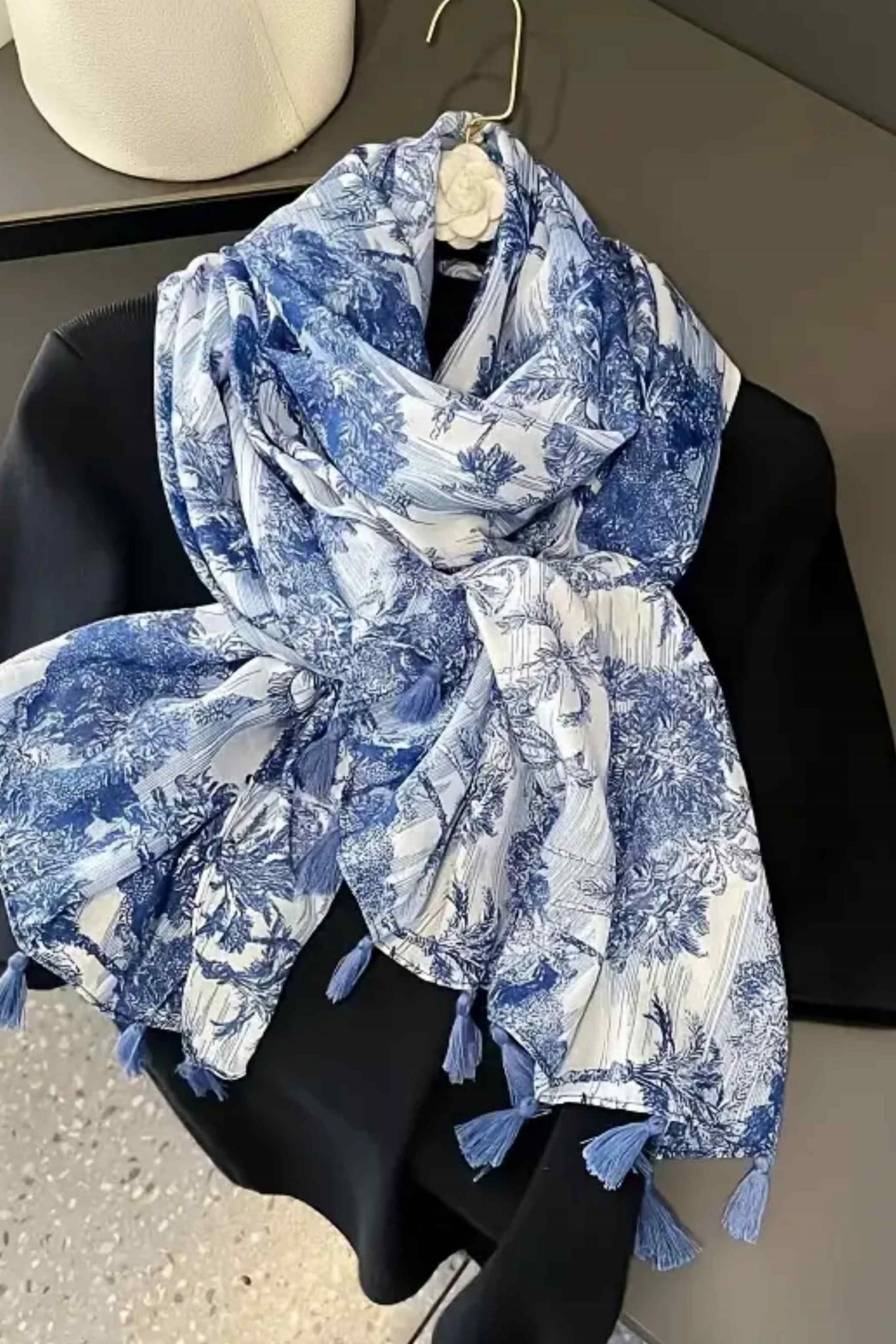 Detal kwiatowego wzoru na szalu damskim w kolorze biało-niebieskim, wykonanym z miękkiej wiskozy | KAMEA | Spironik.pl