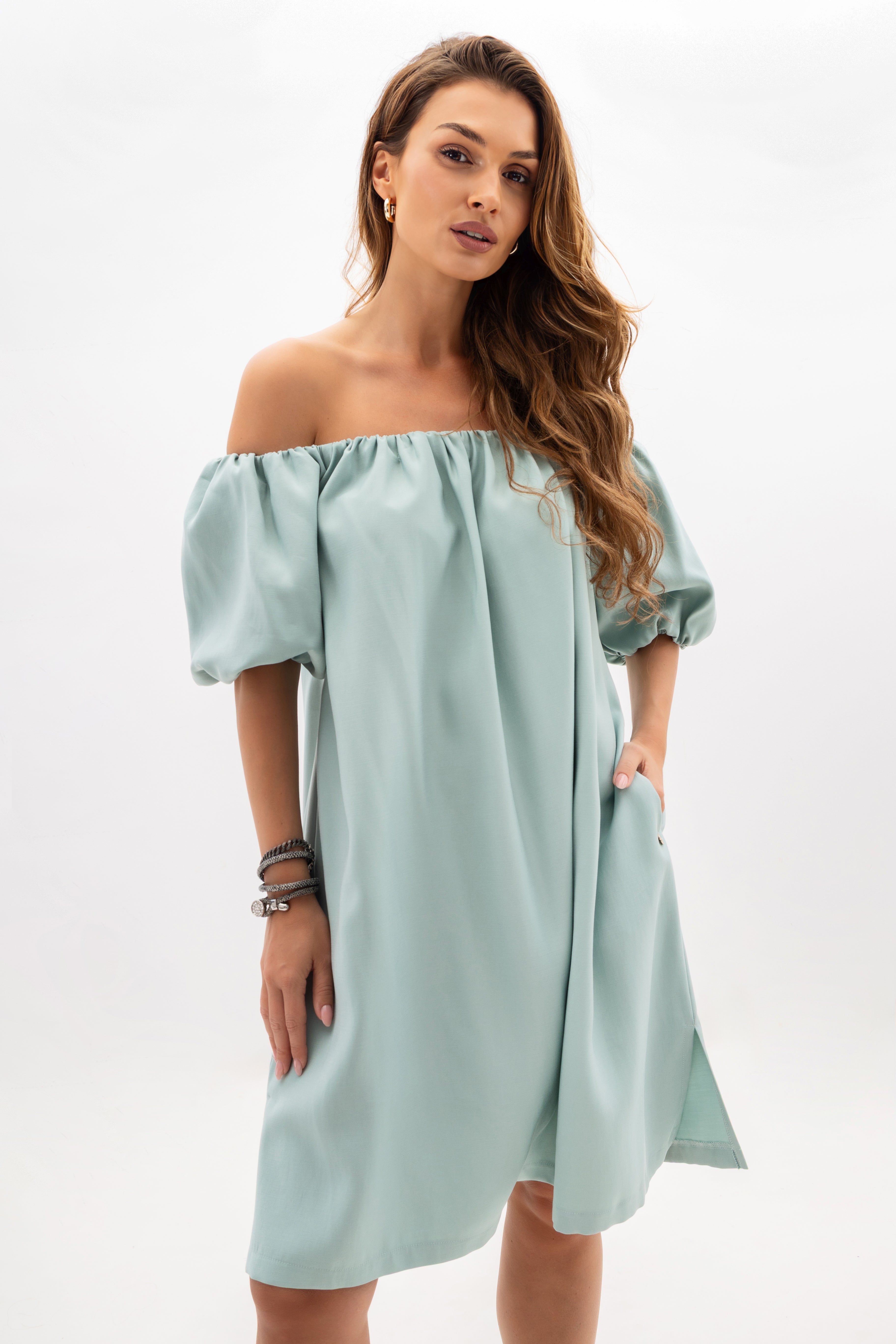 Loose off-the-shoulder dress with a Spanish neckline in mint color — view showing how the dress drapes freely on the silhouette | Bastet | Spironik.pl