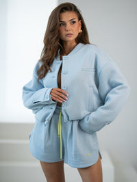 Bomber jacket with logo patch - stand-up collar, buttons, and lining. Color: Sky Blue (yellow lettering)
