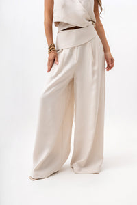 Women's trousers with a decorative belt and wide legs. Light beige color