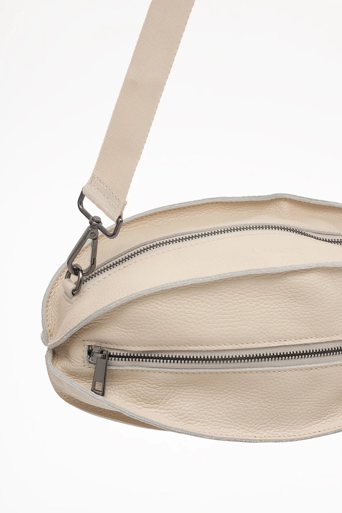 Torebka w formie nerki z naturalnej skóry w jasnym beżu z możliwością noszenia na ramieniu lub w pasie | Bastet | Spironik.pl