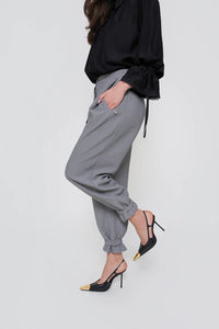 Classic women's trousers with pleats and a belt at the legs. Color: Gray