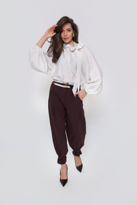 Classic women's trousers with pleats and a belt at the legs. Color: Brown